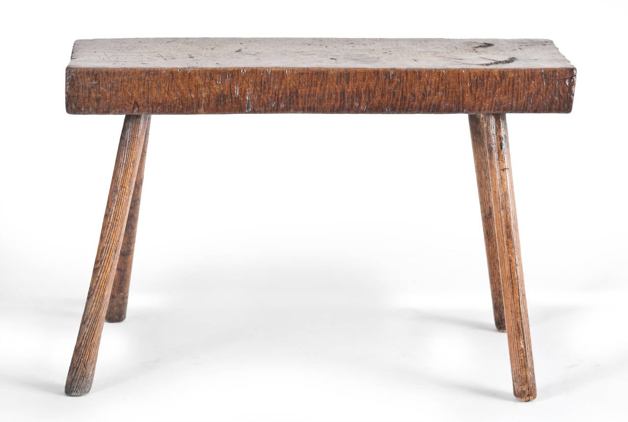 An exceptional 19th century Australian Eucalyptus stool.
The thick plank top having good faded color and patination.
(note the fiddle back grain to the sides).
Supported by four original turned outswept ash legs.