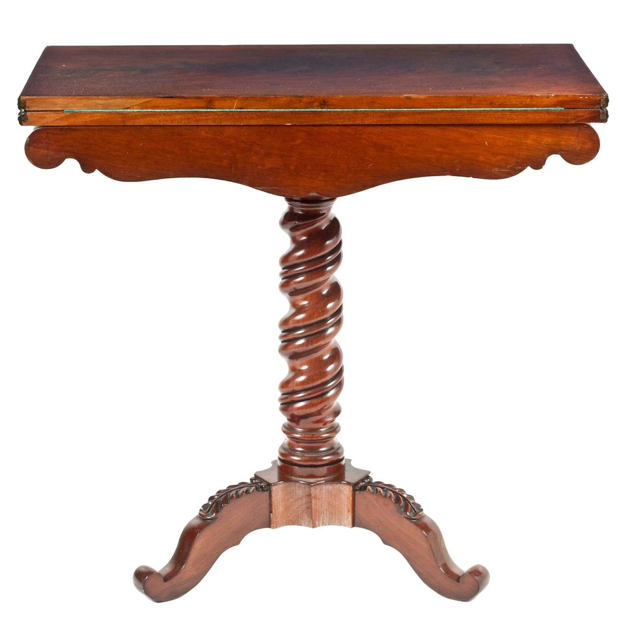A late 19th Century French flame mahogany card table and family photo of.
The single flame moulded top, unfolding to a card playing table, having a decorative book-matched veneered frieze, on a well turned support column, resting on three outswept