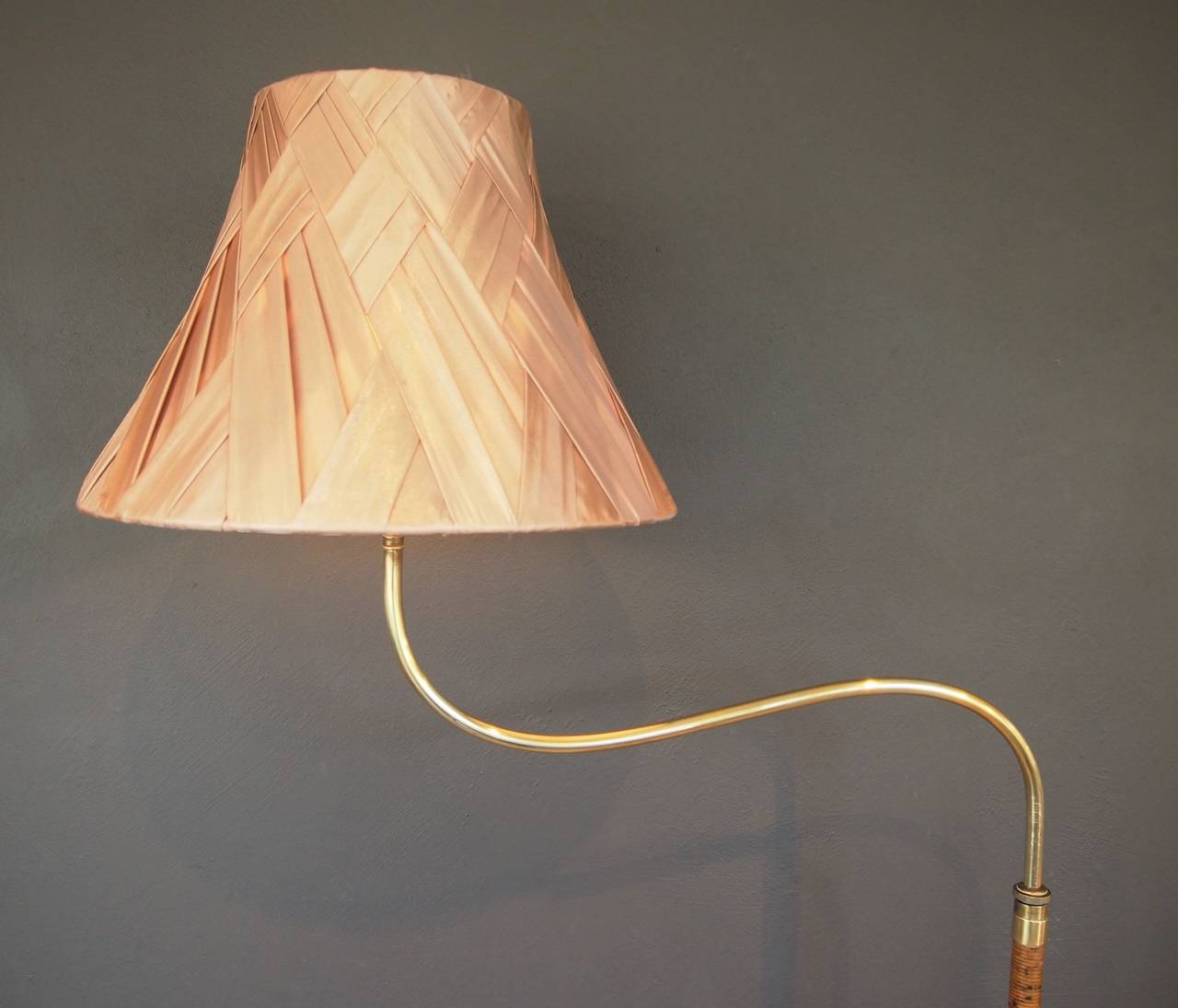 Unique Swedish Art Deco floor lamp. Made from brass with elm foot and coiled bamboo.
The height can be adjusted telescopically and the curved section can be rotated 360 degrees.

Measures: Height 160 cm.
Base 35 cm diameter.
Width of brass stem