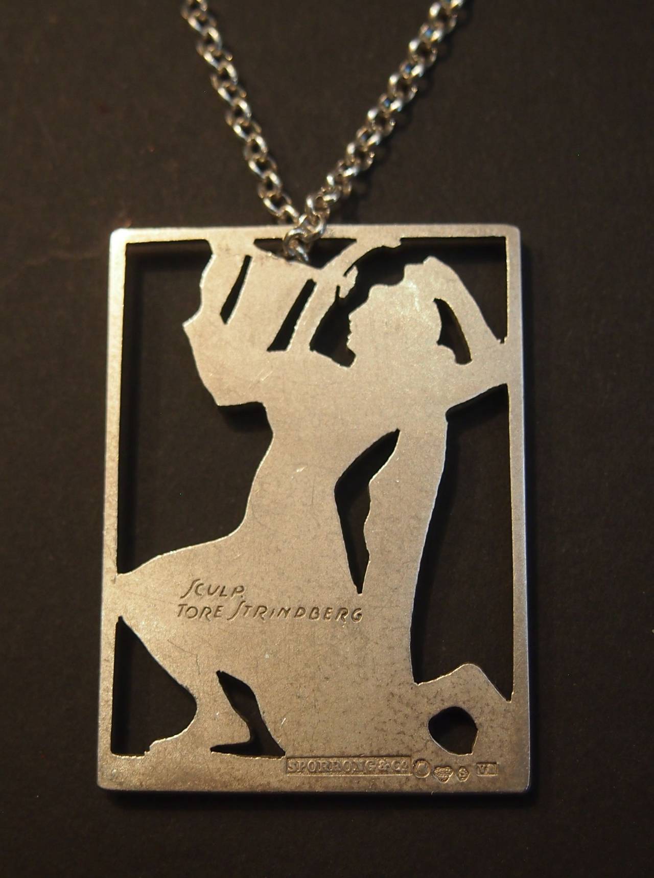 Swedish silver pendant by Tore Strindberg 1882-1968. signed by Strindberg. Made by Sporrong & Co. Date mark 1945. A beautifully detailed pendant depicting a classical Greek maiden with Lute.

Length  45cm
Width    35cm