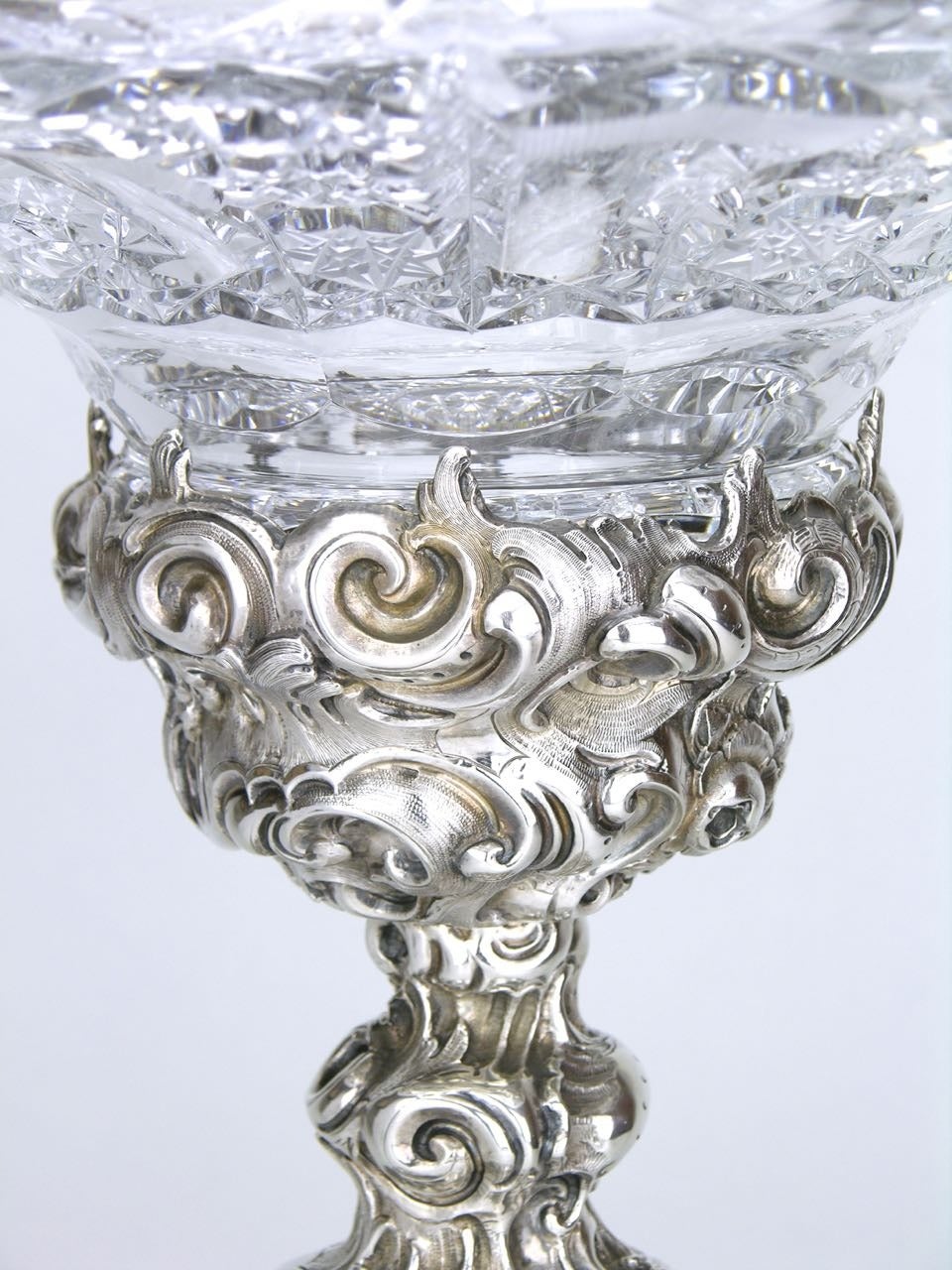 A solid silver and crystal centerpiece of an impressive scale comprised of a hand raised, heavily chased solid silver base in the Rococo Revival style (hallmarked for Vienna 13 loth (813 purity) and for 1836) with a later hand-cut heavy crystal