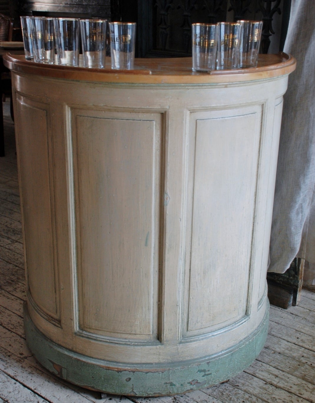 From Lyon, France a petite paneled demilune counter on castors possibly used to sell tickets at a fair or carnival, very well preserved original paintwork. On the interior side is a curved drawer and two interior cupboards.