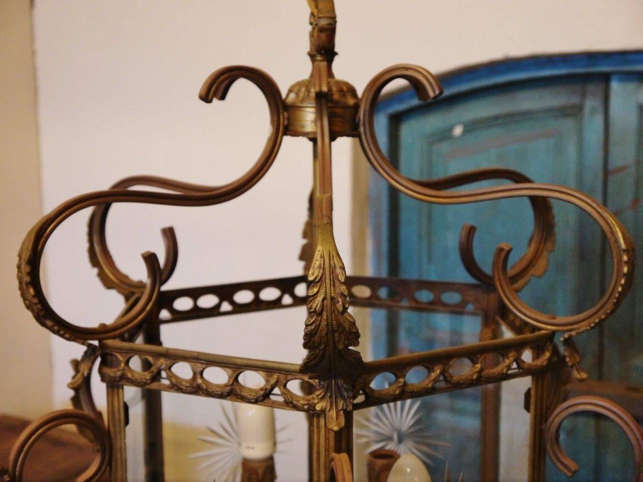 A fine quality 19th century ornate bronze lantern with four panels of etched glass & bevelled glass. Rewired to Australian standards with six candle style lamp holders and aged bronze chain with small ceiling rose.