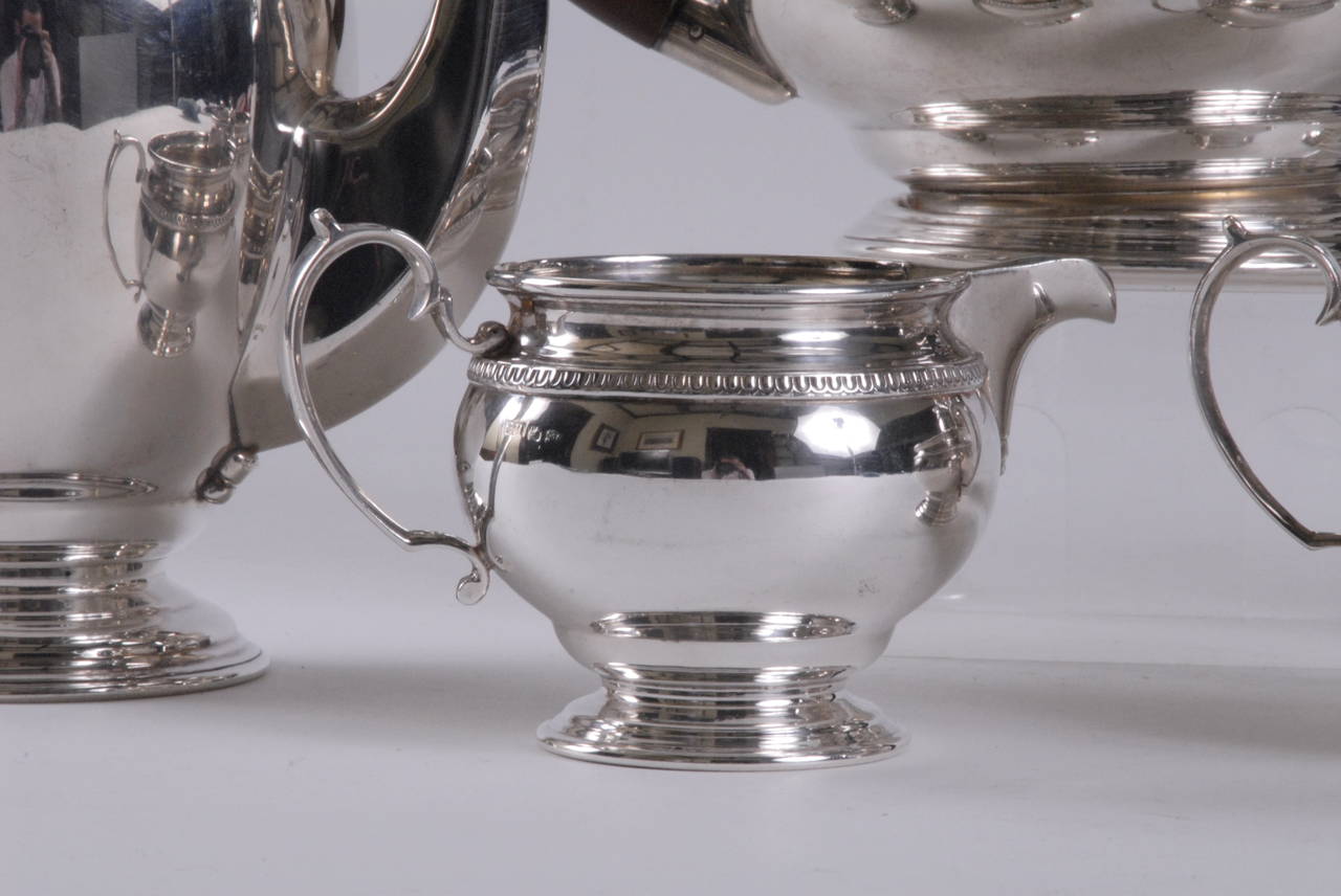 A complete sterling silver tea and coffee service by Hardy Bros. Sydney, comprising a tea pot, coffee pot, hot water pot, sugar basin and creamer. Decorated in a mid-century pattern with plain bodies and stepped bases.
Hallmarked for Hardy Bros on