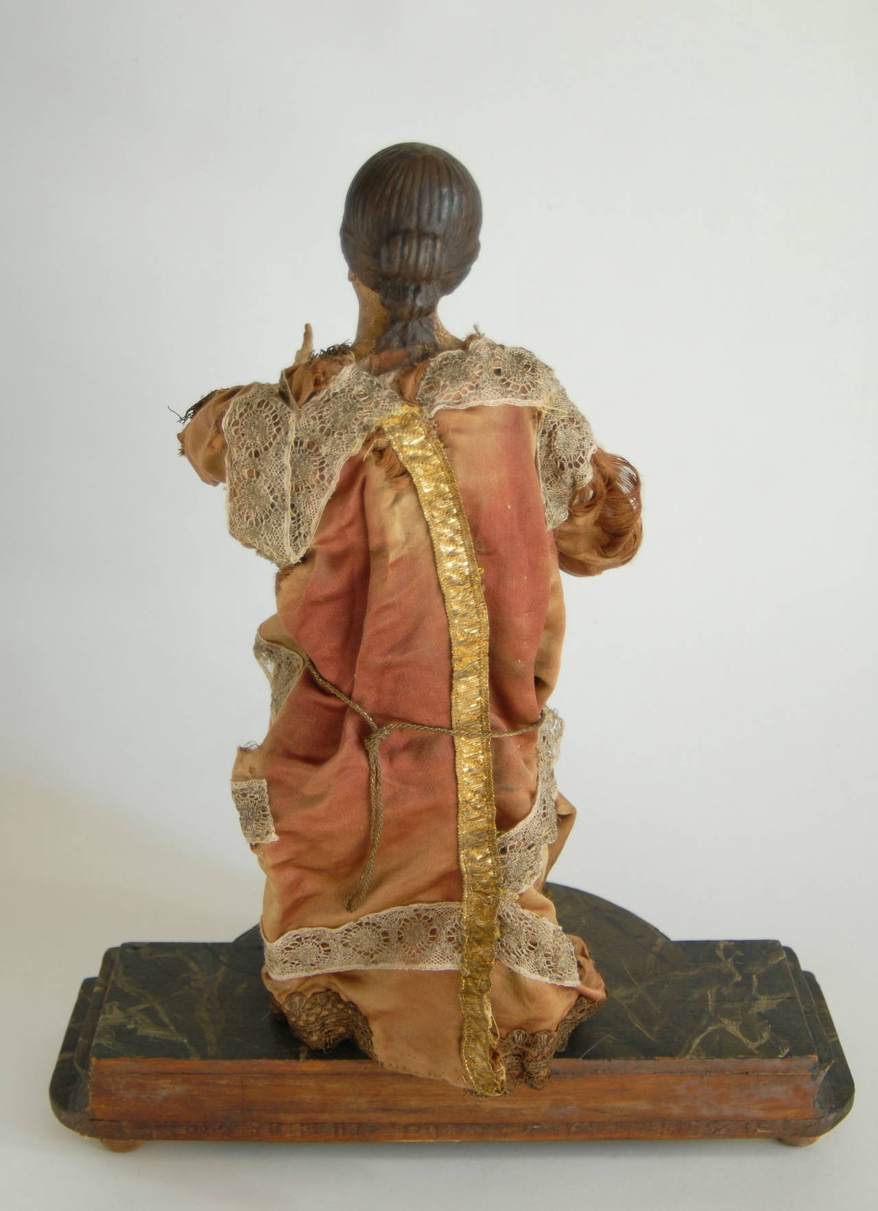 An Italian nativity figure from, circa 1840 with its original fabric costume.
Carved from wood with articulated arms, gesso finished head, feet and hands and forearms, painted in naturalist colors, possibly re-painted at later times to maintain