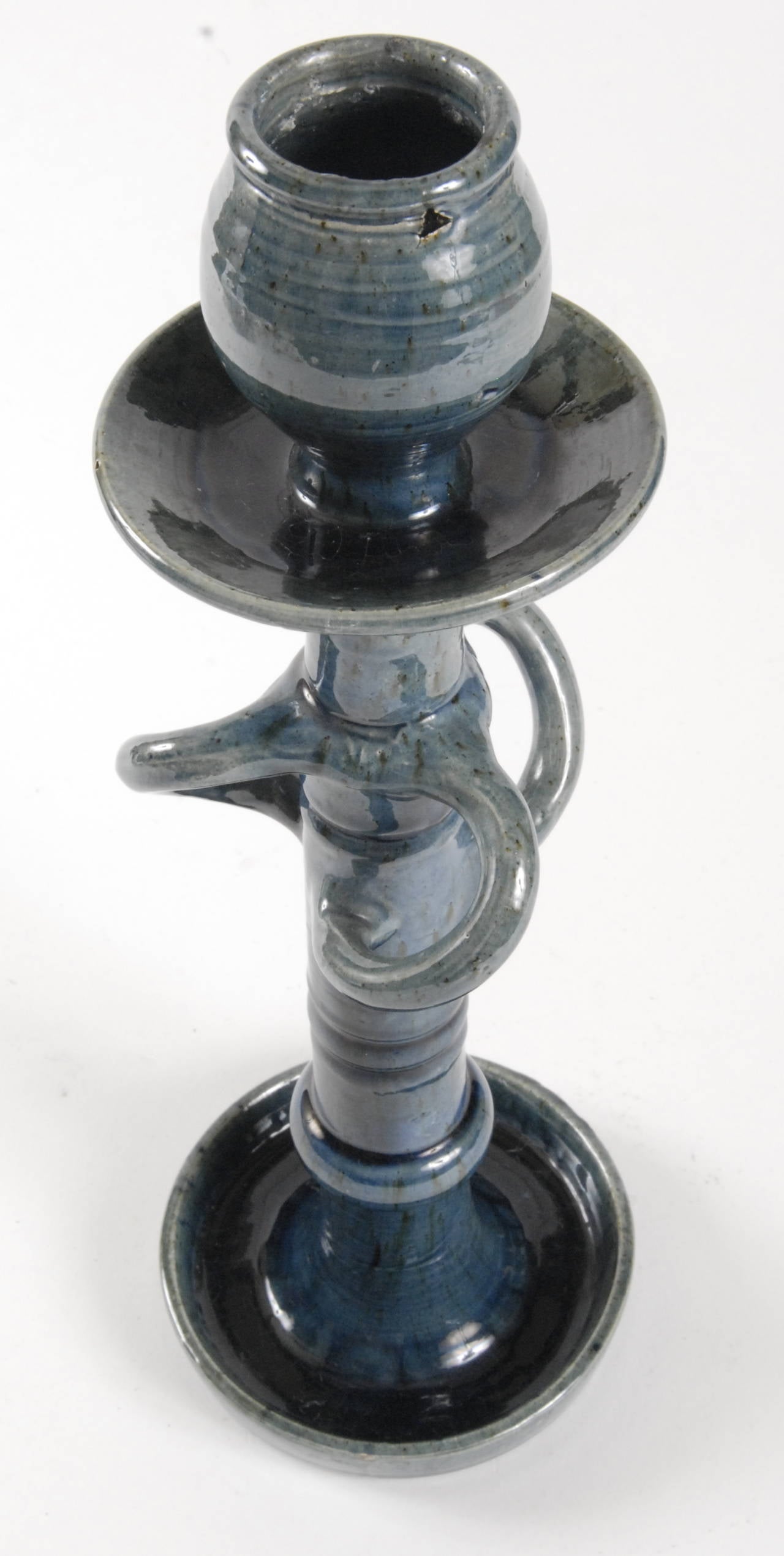 An Art Nouveau, circa 1905, pottery candlestick in a rich blue glaze. In perfect condition bar a heat mark to part of the candleholder bulb, as photographed. Belgium maker unknown, as marked to base and with a shape or pattern number.
