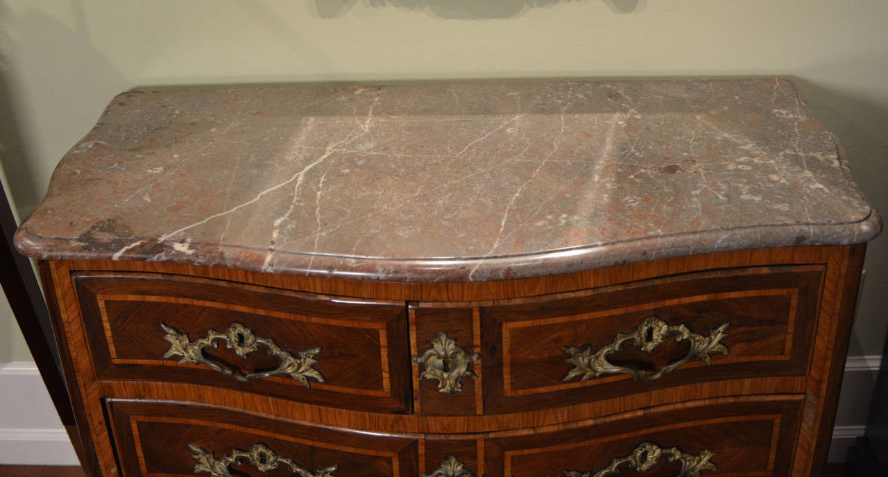 French 18th century Regency signed marble-top commode.  Rosewood, and Kingwood veneers with serpentine front, and bombe ends.  Original gilt brasses with full height to the feet.  Lovely original brown, and gray marble top.  Stamped JME Lardin