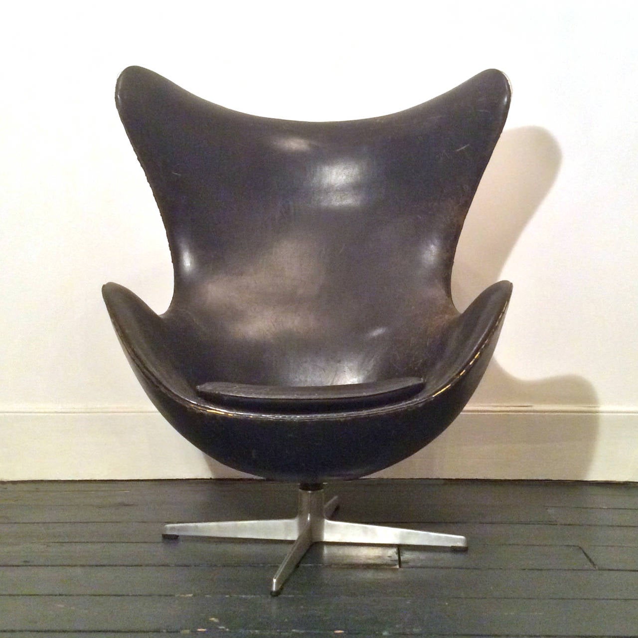 Early egg chair by Arne Jacobsen for Fritz Hansen.  Denmark, 1960s.

A beautiful chair with great character.  The chair is in completely original condition with lots of age related wear to the upholstery (including one small break in the leather