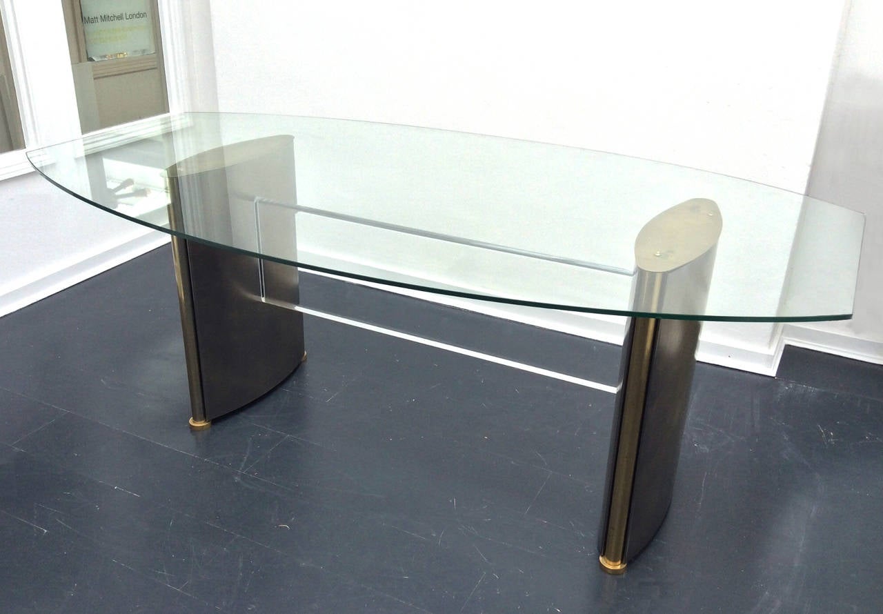 Dining table attributed to Belgo Chrome, Belgium, 1970s. Available with or without top.

A statement piece with bronze patinated steel legs and brass-plated trim with thick Lucite stretcher. In these images the table is shown with the original