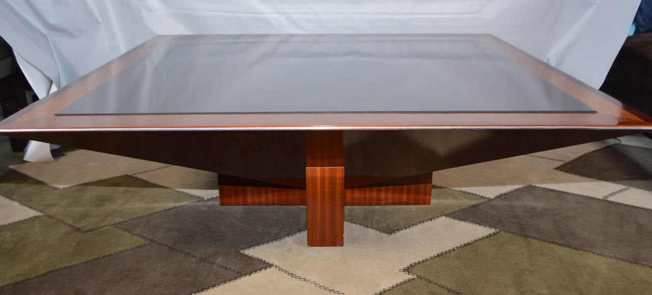 Gorgeous and original convex conversation piece. This elegant low table is finished in ribbon stripe mahogany with stainless steel outer trim and a raised beveled black granite center insert.