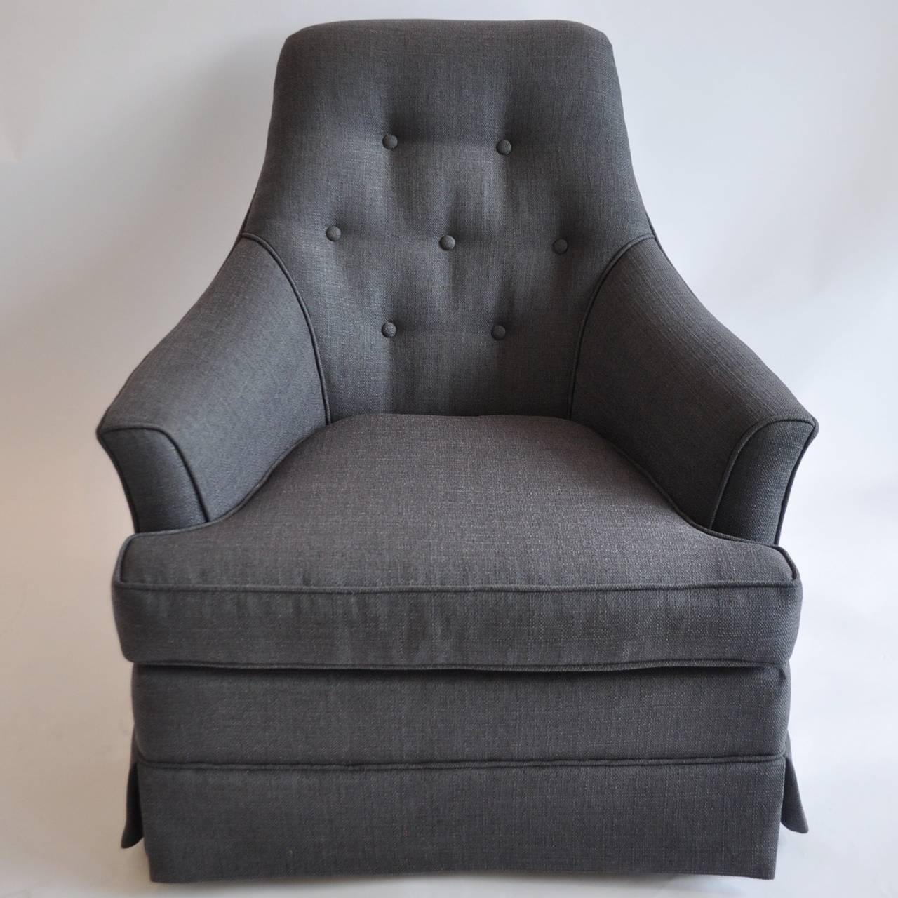 Great pair of chairs reupholstered in charcoal linen. Chairs have castors underneath their skirts and can turn/swivle easily.