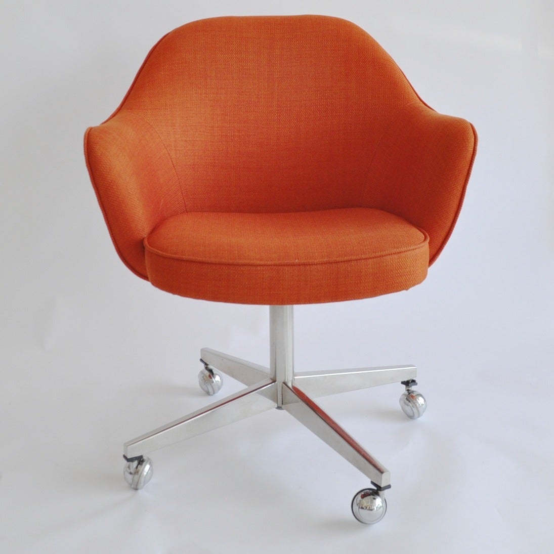 Vintage desk chairs with polished aluminum base and casters.
Newly upholstered seats in orange linen fabric.