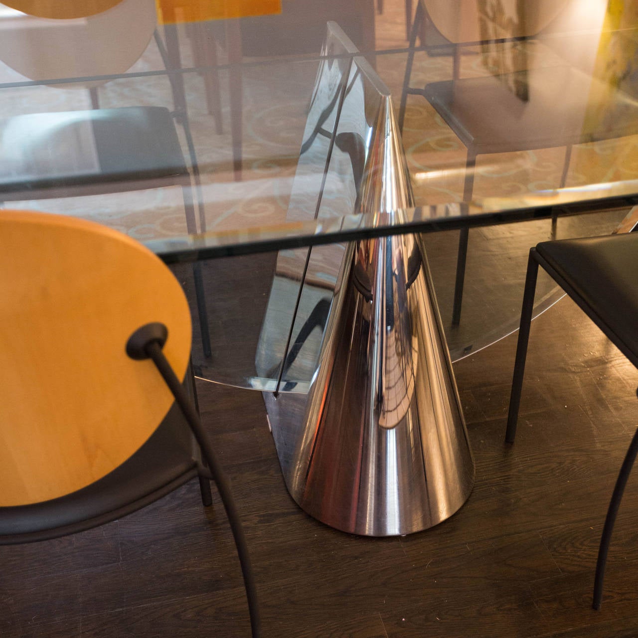 This is the Pinnacle Table designed by J. Wade Beam for Brueton. This classic modern design features a polished stainless steel conical center pedestal intersected by 3/4