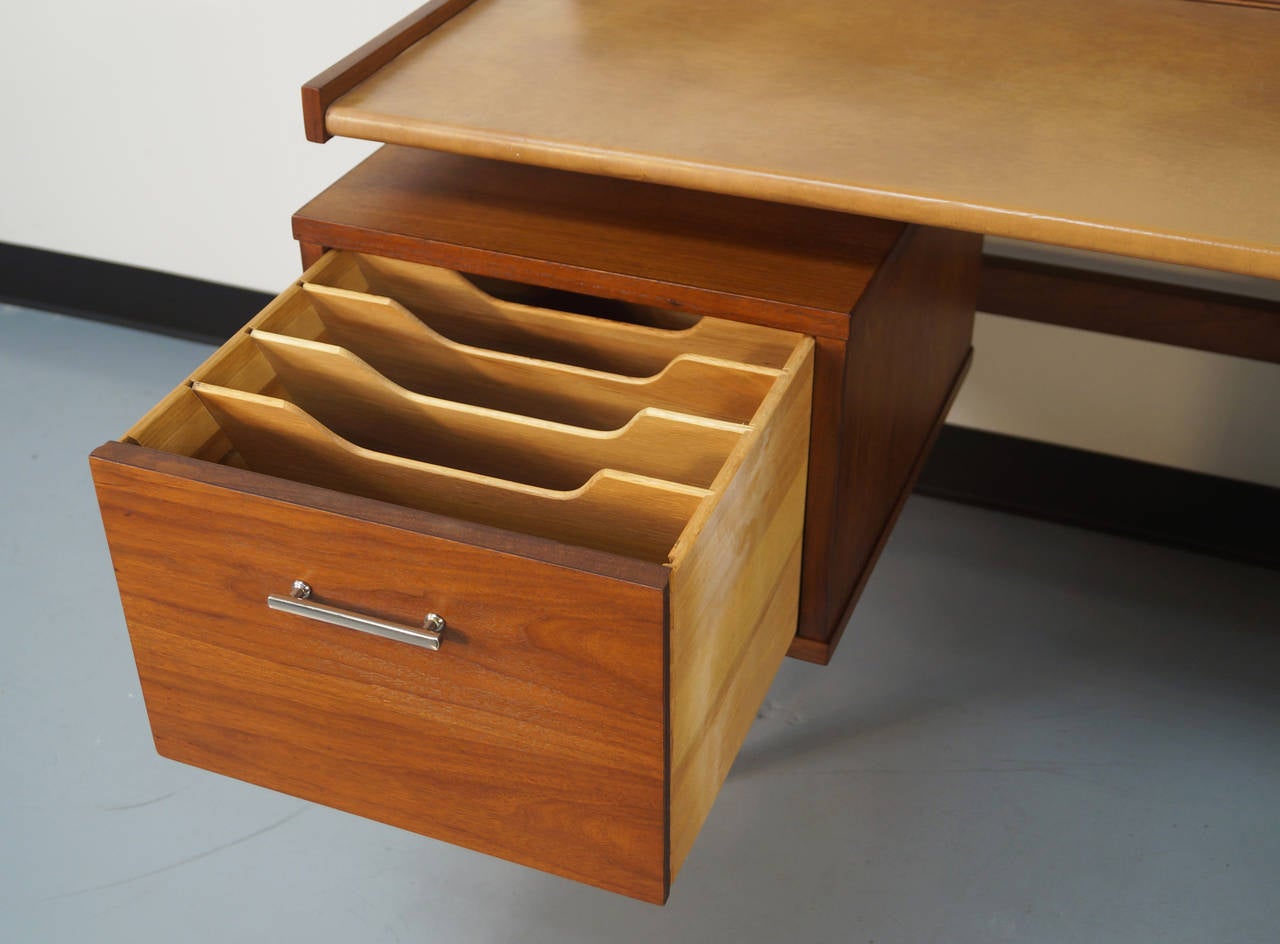 Floating top desk by Drexel. Features chrome pulls and leather top. The left drawer has a file slot which can be removed if needed and on the right side has two dovetailed drawers. Top compartments has two sliding doors with compartments inside.