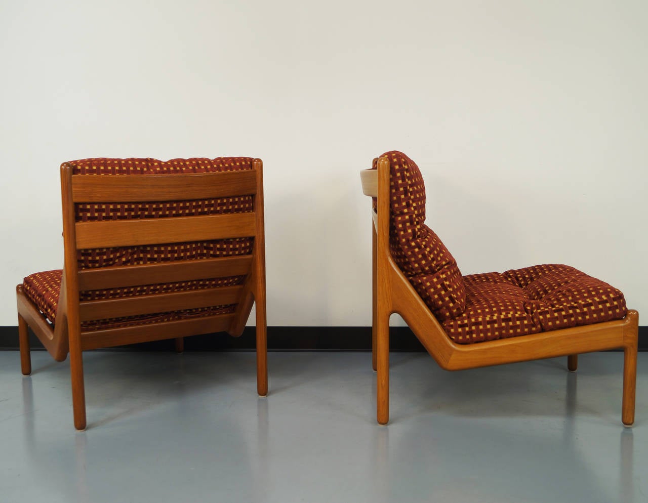 Pair of solid teak lounge chairs designed by Niels Bach.