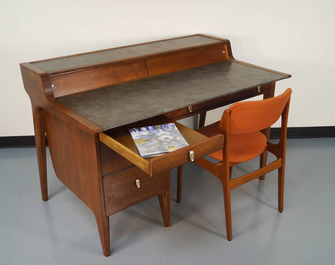 This Modernist desk derives it beauty from its lines and its incredible craftsmanship. It was designed by John Van Koert for the Drexel Profile series. The back of the desk is as amazing as the front, so it can float in the middle of a room. Desk