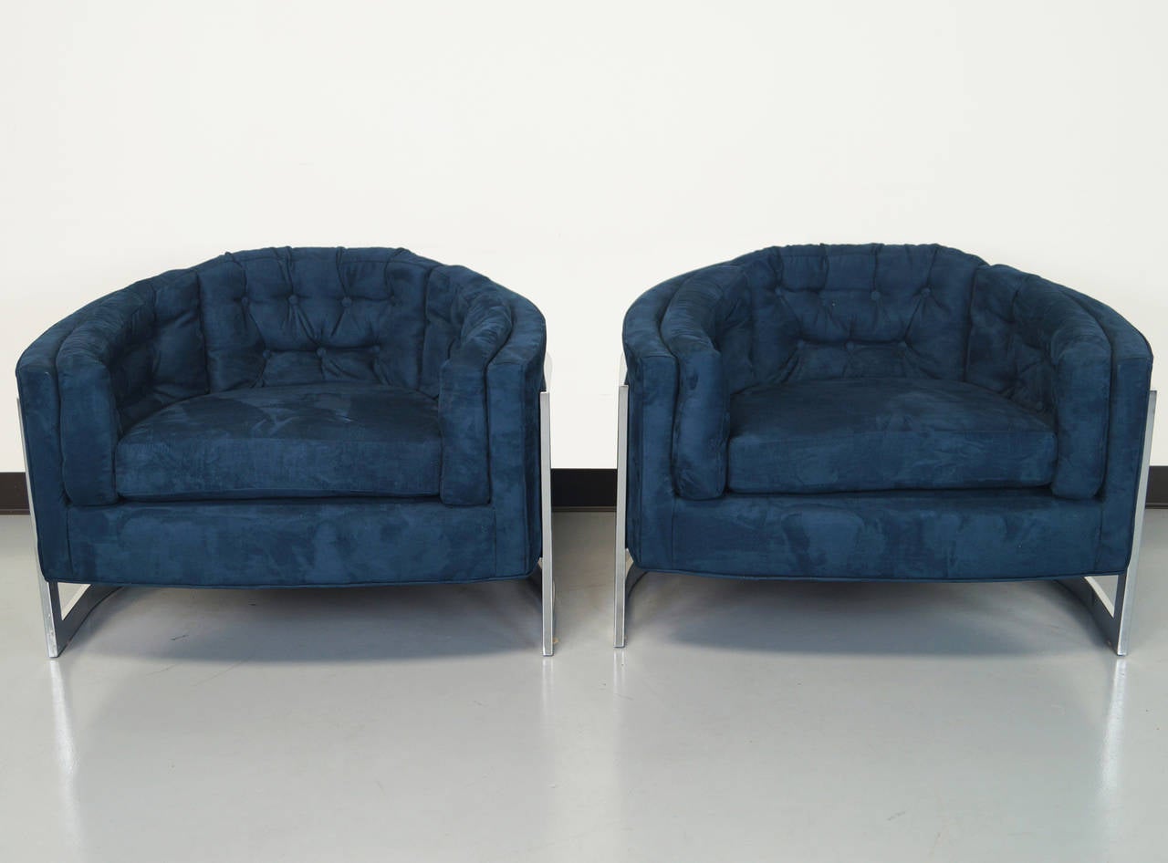 These stunning pair of oversized cantilevered barrel lounge chairs was designed by Milo Baughman. These gorgeous lounge chairs features a floating seat design. Newly reupholstered in a navy blue Ultrasuede.