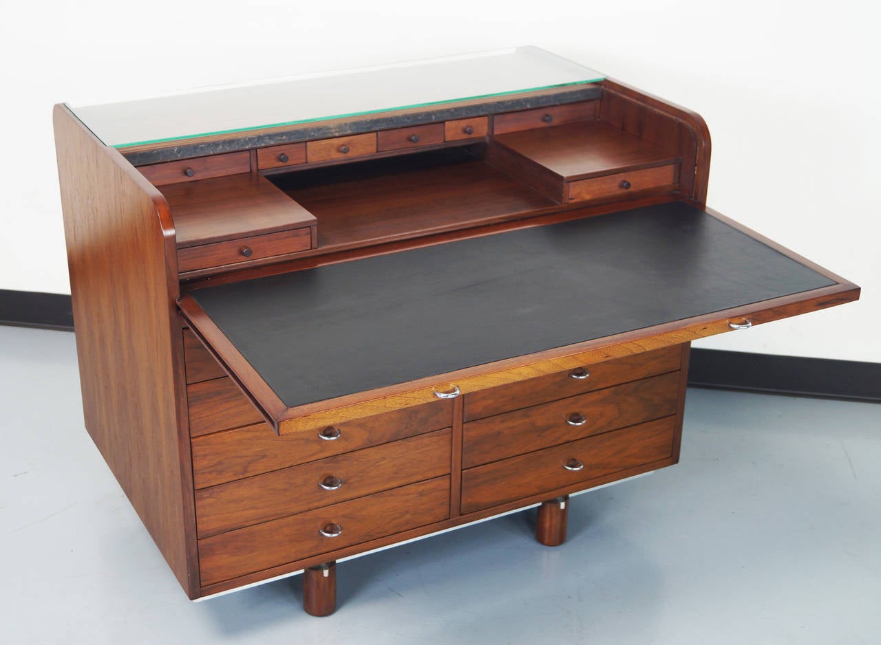 Vintage writing desk by Gianfranco Frattini for Bernini, Italy. This roll top design opens by pulling out the leather writing surface. The glass shelf remains in place to hold items while roll top is moving. Inside conceals eight drawers and ten