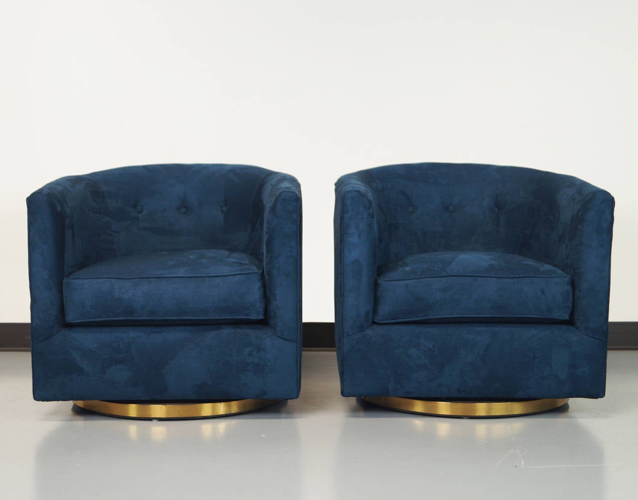 A pair of stunning brass swivel chairs attributed to Milo Baughman.