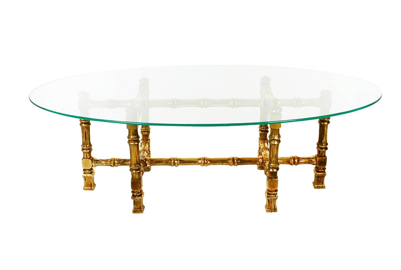 A very rich and chic looking cocktail table that can marry with many design aesthetics. It features a solid wood gold gilded base with heavy glass top.