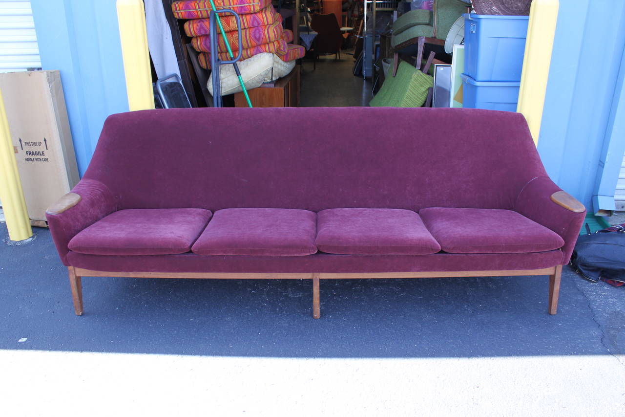 This gorgeous Danish modern sofa is an ample 92.75 inches long - a rarity in sofas of this era.  Gorgeous teak armrests and stretchers.  Velvet upholstery is acceptable, but does show light wear and two small holes, one near the left arm, the other