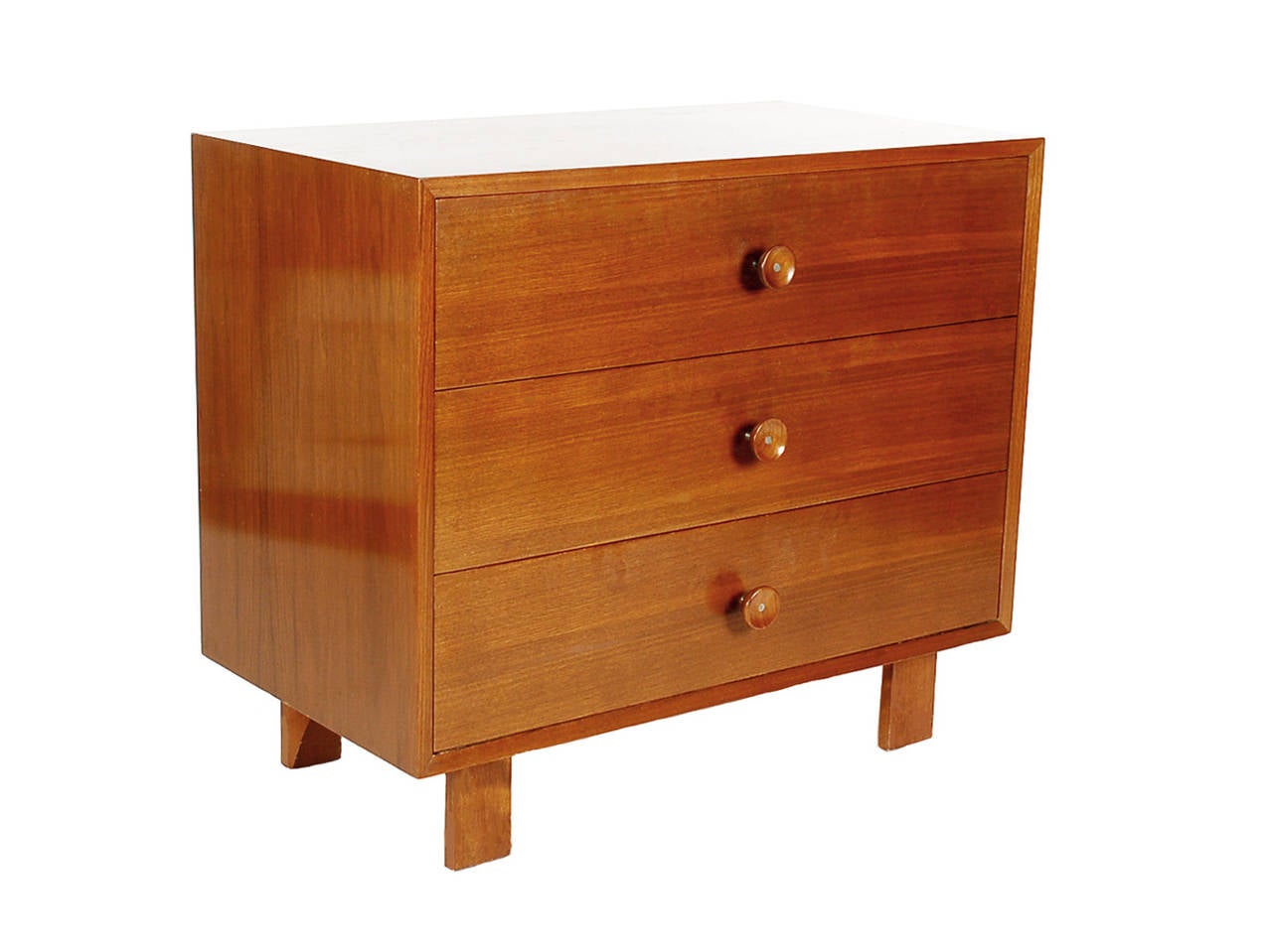 A nice low key chest designed by George Nelson for Herman Miller. It features walnut legs and walnut pulls on walnut case. Manufacturer label.