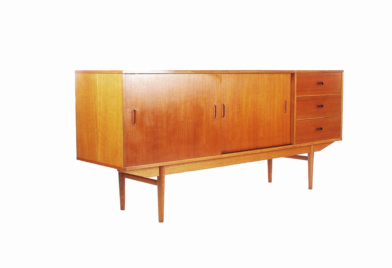Danish style credenza made of teak from Belgium, with sliding door and drawers, circa 1960.