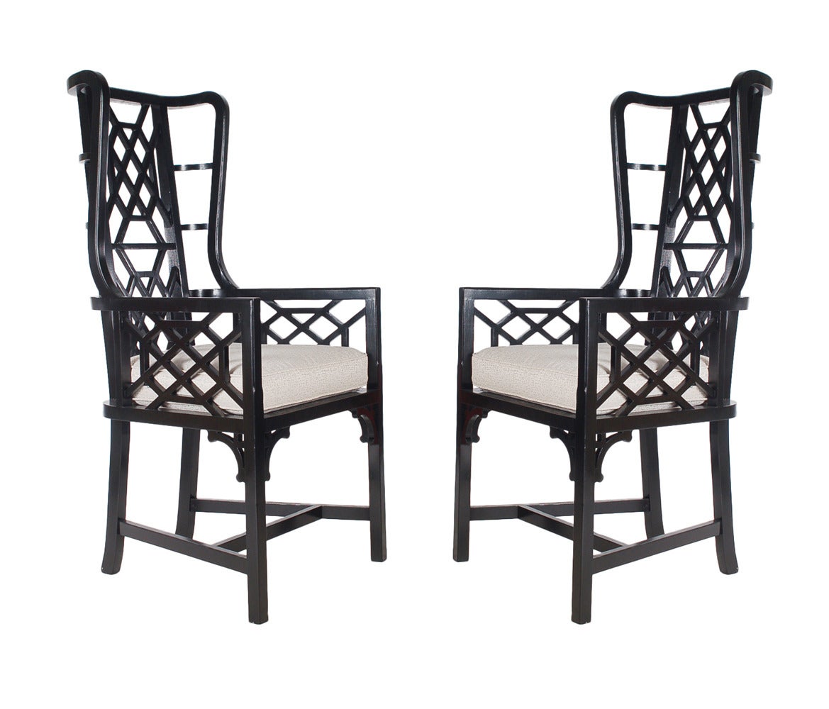 A lovely matching pair of modern wingback armchairs with an Asian flair. They feature fresh black lacquered frames with a modern print seat cushion.
