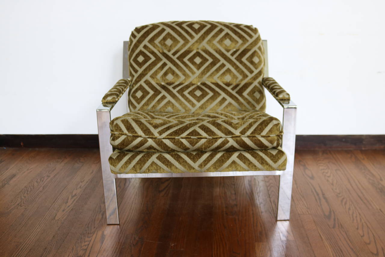 This striking chair designed by Cy Mann is constructed of a heavy flat bar chrome frame.  Newly upholstered in a lovely cut chenille fabric in olive green and grey.
