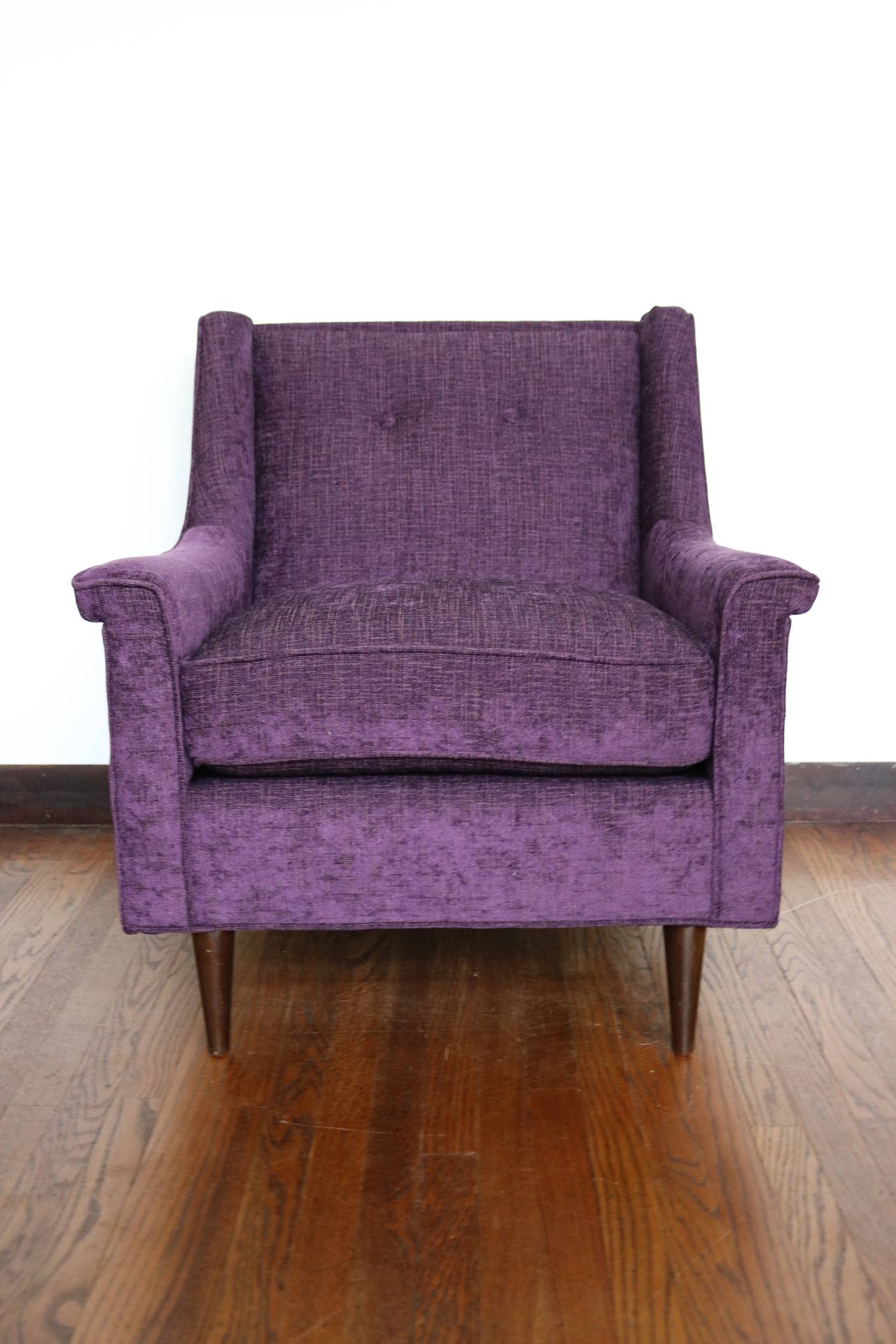 This lovely mid century armchair has been fully restored.  Lovely aubergine chenille with rust threads set off the walnut lets.  Comfortable and stylish!