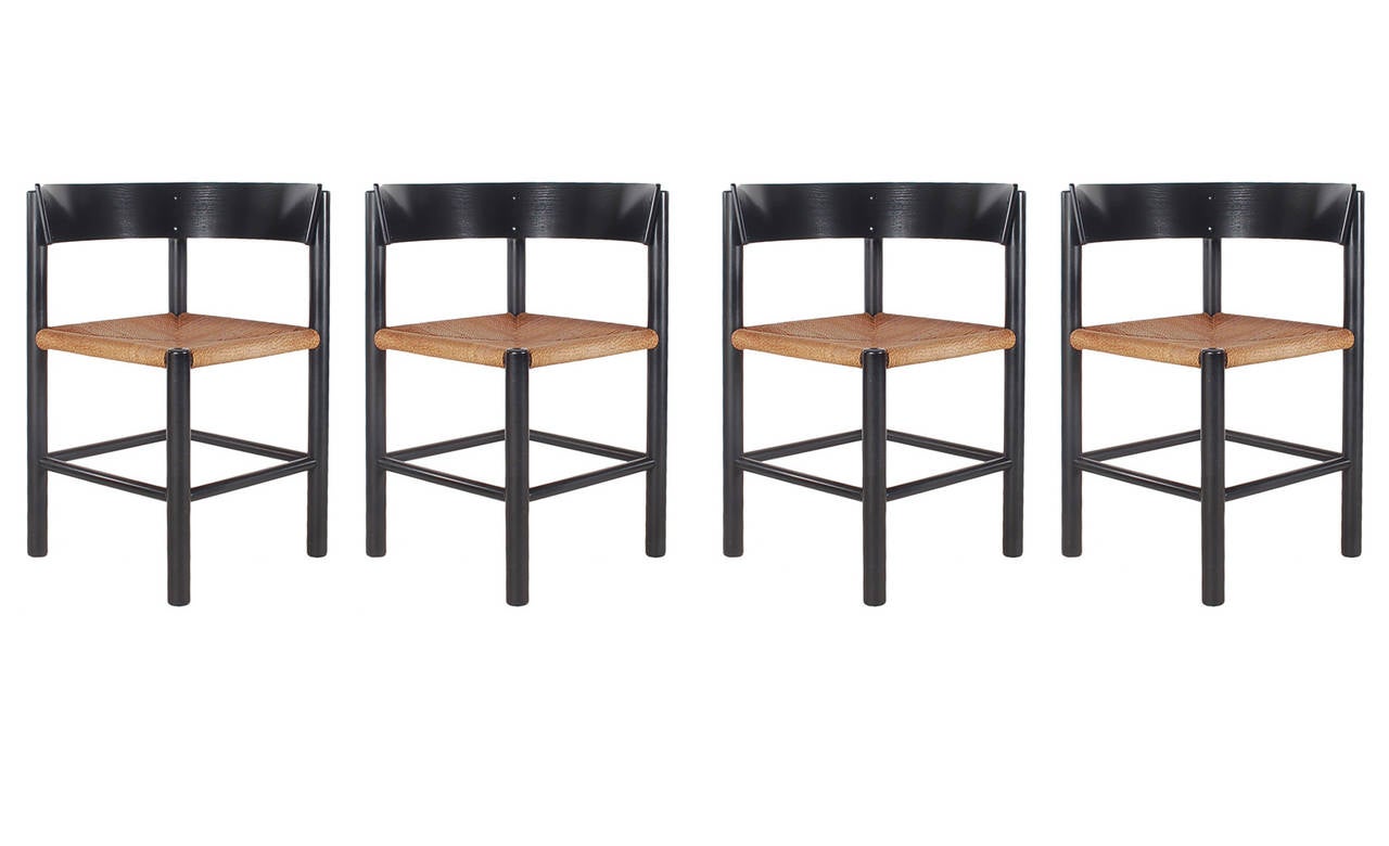 A hard to find complete table and chair set designed by Moggens Lassen for Fritz Hansen. It features black enamel finish with rope seats. Comes with copy of original receipt from1963.