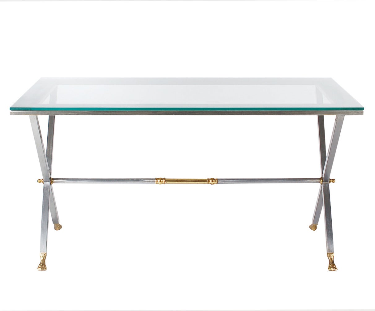 A modern, yet traditionally stylized piece of furniture. A truly versatile and chic looking table for any room of the house. It features a heavy steel frame with brass accents and glass top. It is very well made circa 1960s and marked Made in Italy.