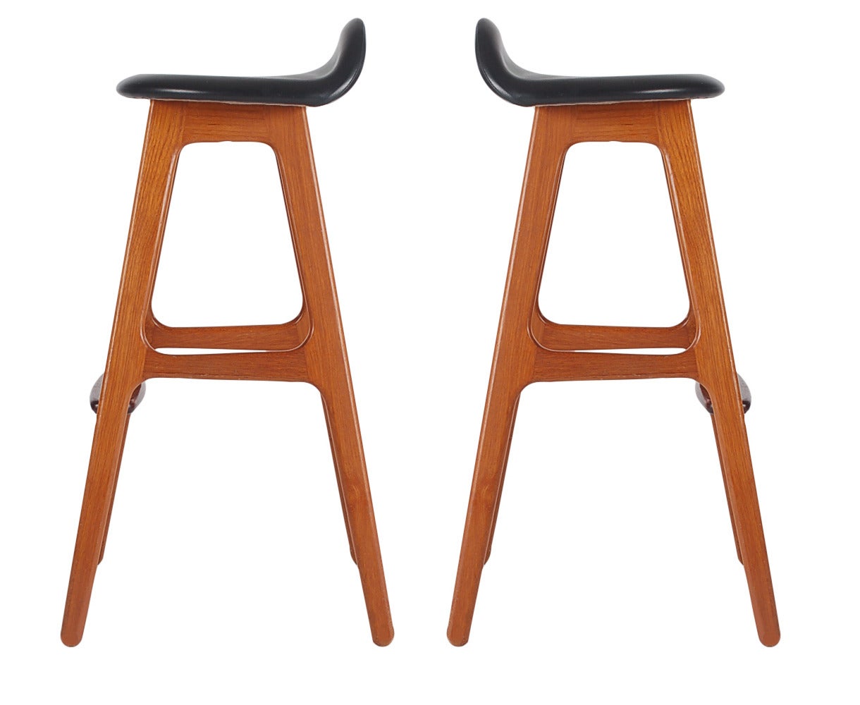 A nice vintage pair of barstools by Eric Buch for OD Mobler Denmark. Produced in solid teak with rosewood foot rests. Manufacturer labels to both.