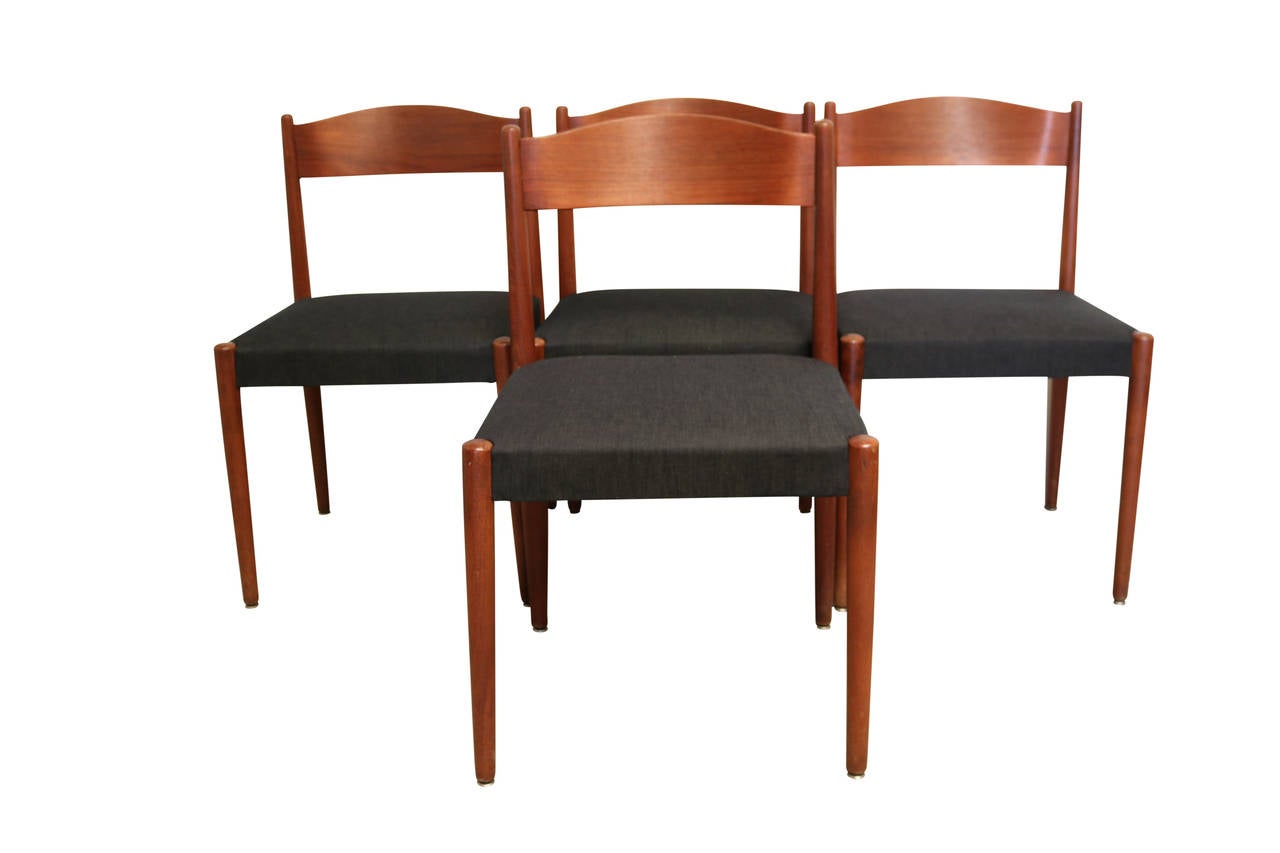This set features an excellent and rare folding dining table and four chairs designed by Poul Volther for Frem Rojle. Chairs have been newly upholstered in slate grey fabric. Excellent vintage condition - only a minor bit of wear to the top when