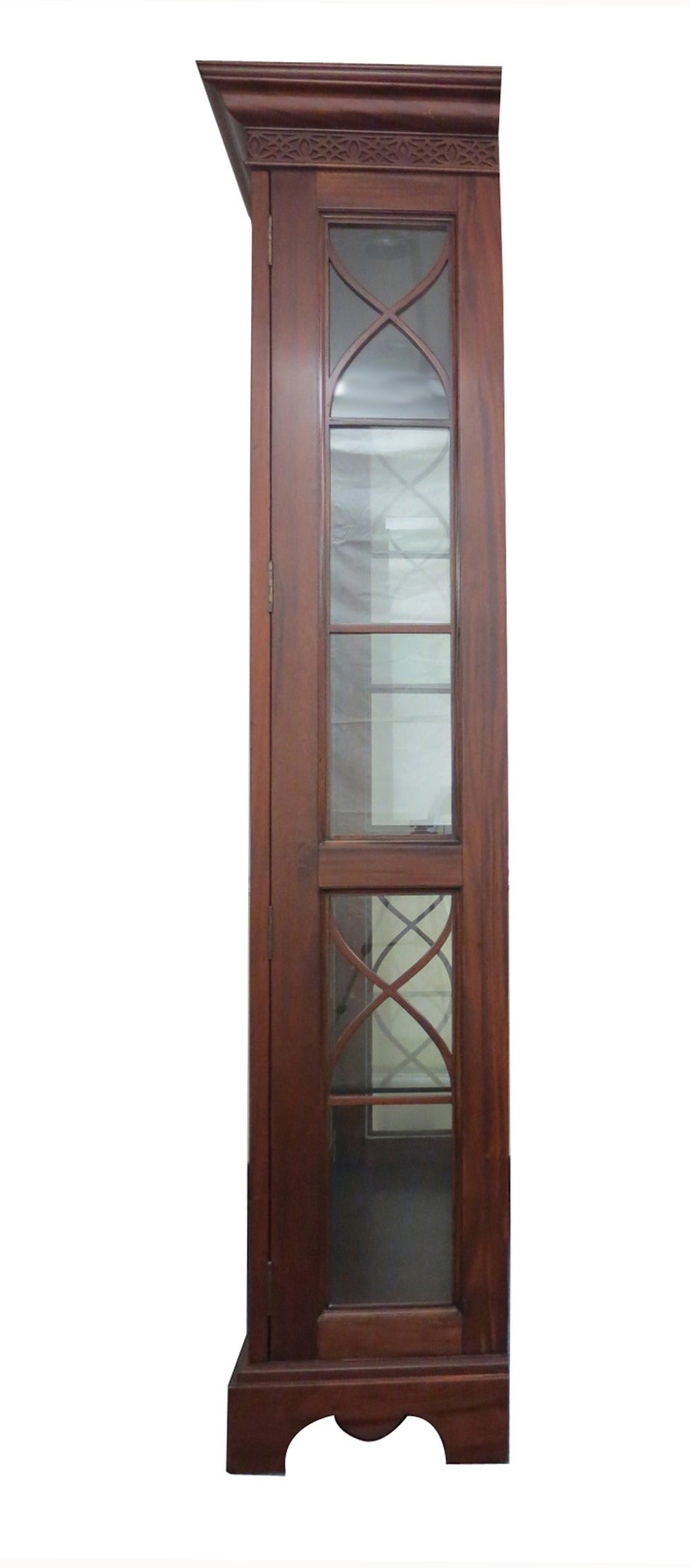 Large mahogany display cabinet with center mount acorn finial flanked by scroll acanthus brackets.   The interior consists of 4 glass shelves and the back is mirrored. The side panels are glazed and the glass is framed in rope trim.