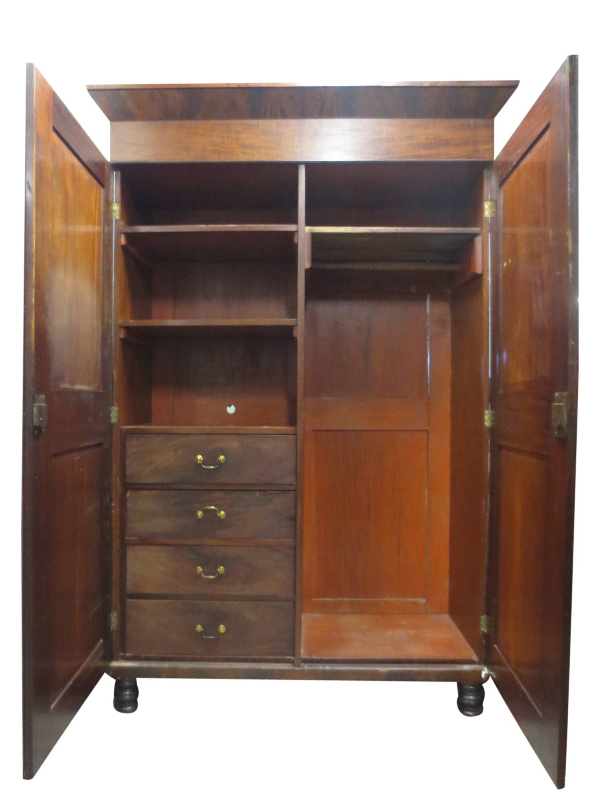Mahogany armoire with two doors and four drawers.  Armoire disassembles for easy transport. The top lid opens up and contains additional storage, circa 1820.