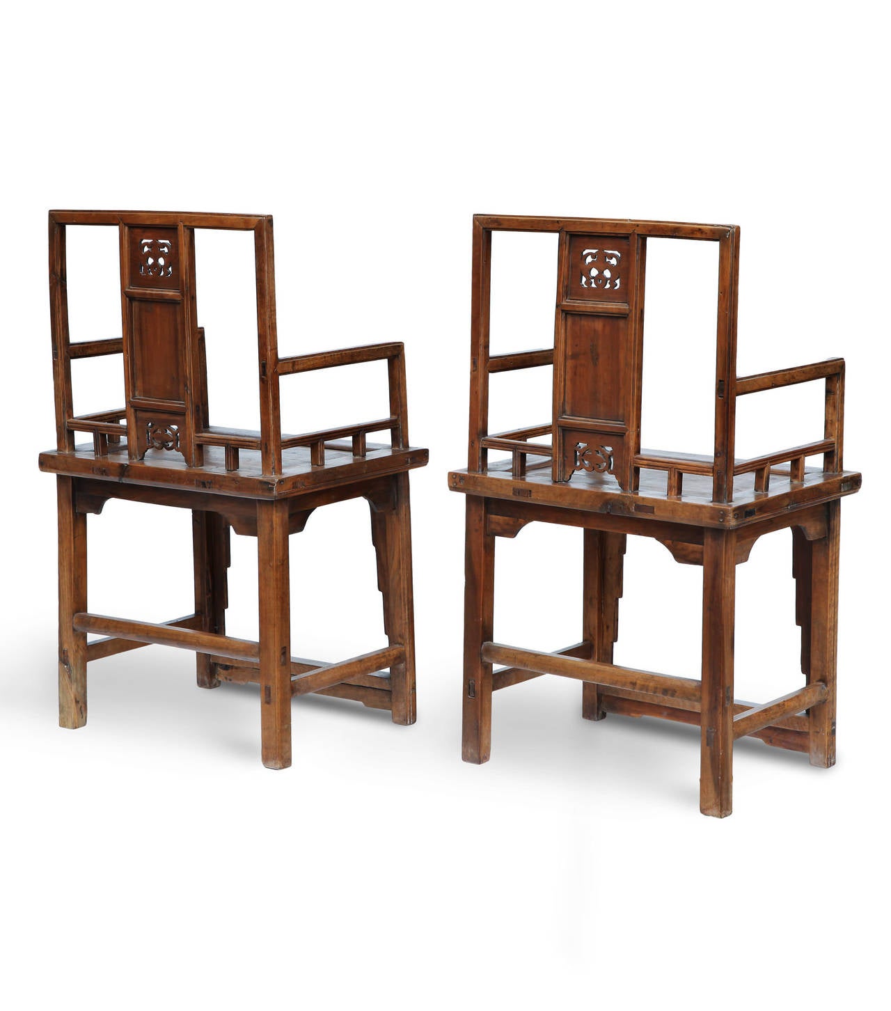 Pair of antique chairs made of camphor wood, a rare and precious material. 
At the center of the back there is an elaborate frieze full of meaning: a bat holds an amulet, symbol of good luck. Is finely carved also the endless knot which symbolized
