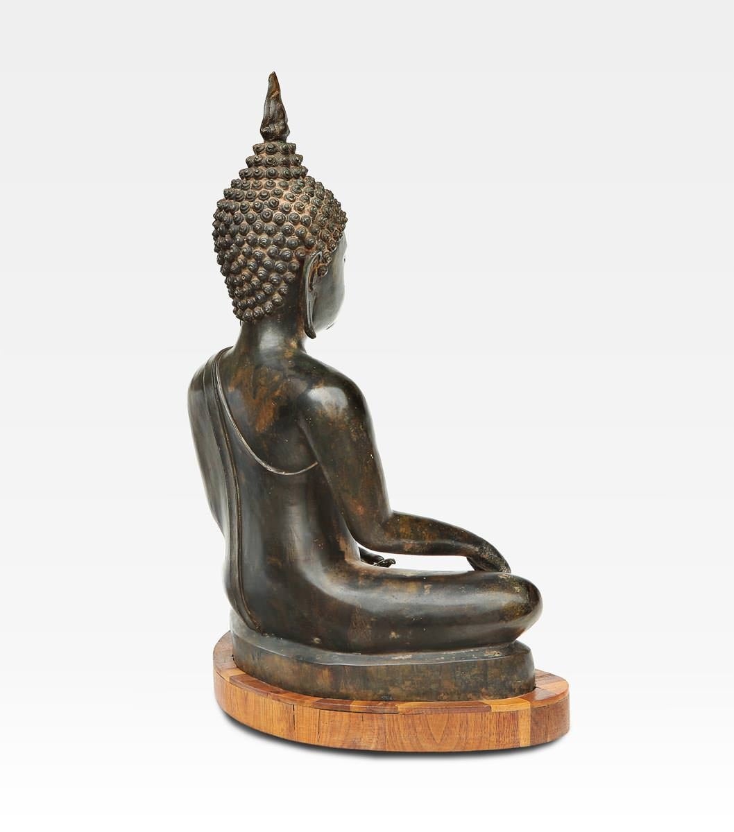 This beautiful sculpture representing a Thai Buddha in position Bhumisparsamudra. In this position the right hand  resting on the knee with the palm down and the fingers that touch the ground. The Buddha takes this position when it reaches the