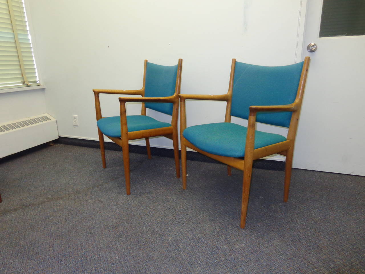 A pair of Hans Wegner FH-513 armchairs in oak with original teal upholstery