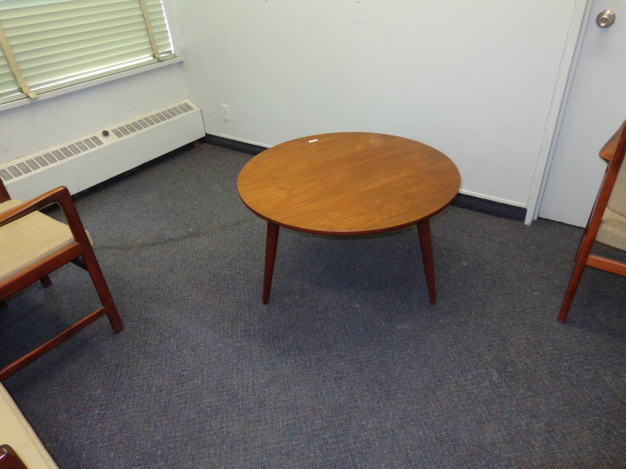 Hans Wegner circular teak coffee table with three tapered legs. Manufactured by Andreas Tuck.