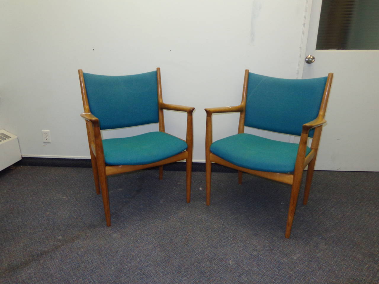 A pair of Hans Wegner FH-513 armchairs in oak with original teal upholstery.
