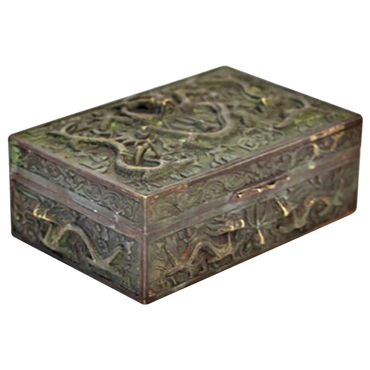 An early 20th century copper box with a striking design of nine flying dragons, each in relief with four outstretched claws, horns, whiskers and sinuous bodies. Circa 1920. 

The lid of the rectangular brass box has three dragons including one