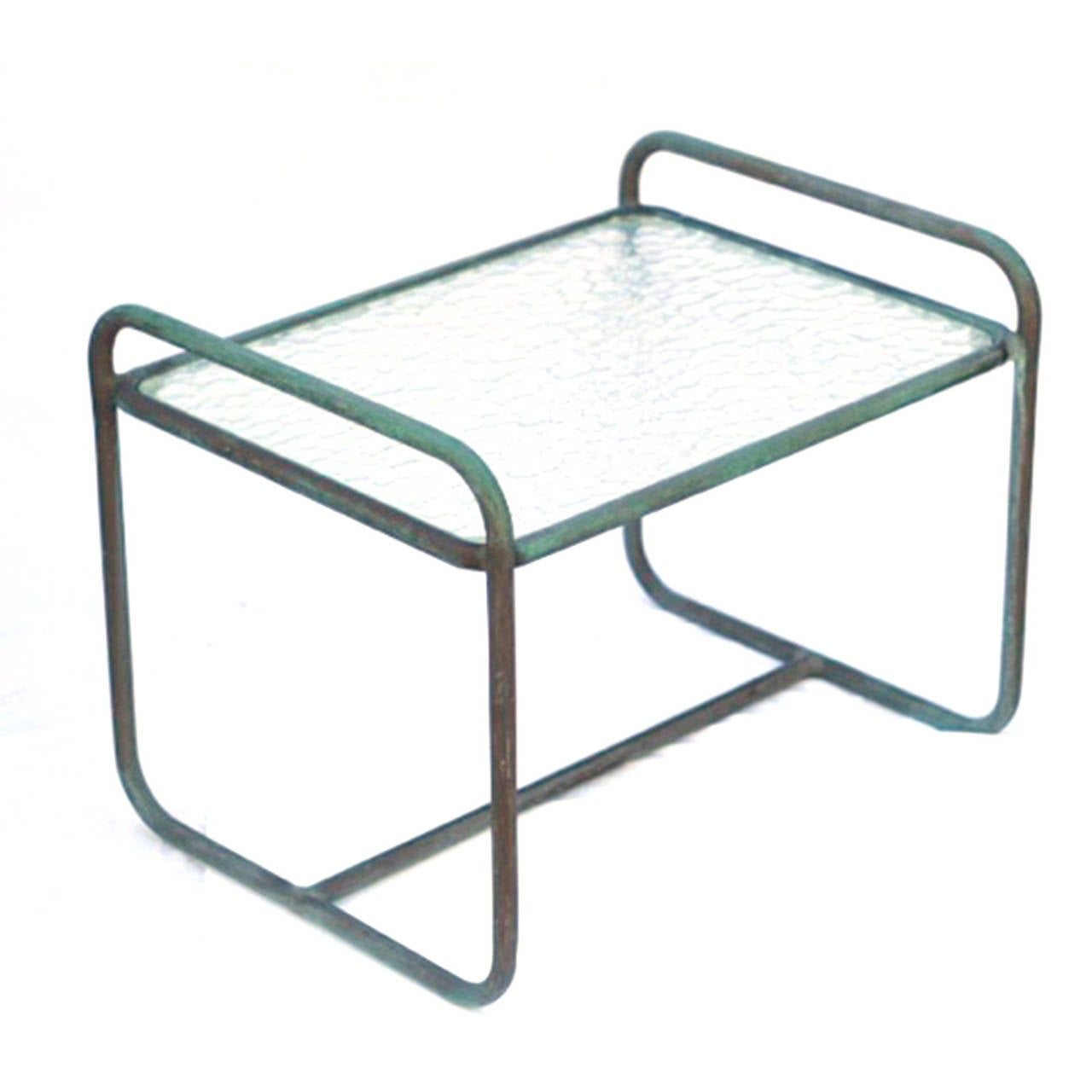 Low side table in bronze by Walter Lamb, circa 1950s. Table has a lovely green patina with a plastic insert. Glass can be replaced for minimal cost. 

We have an extensive Walter Lamb collection. Email for details.