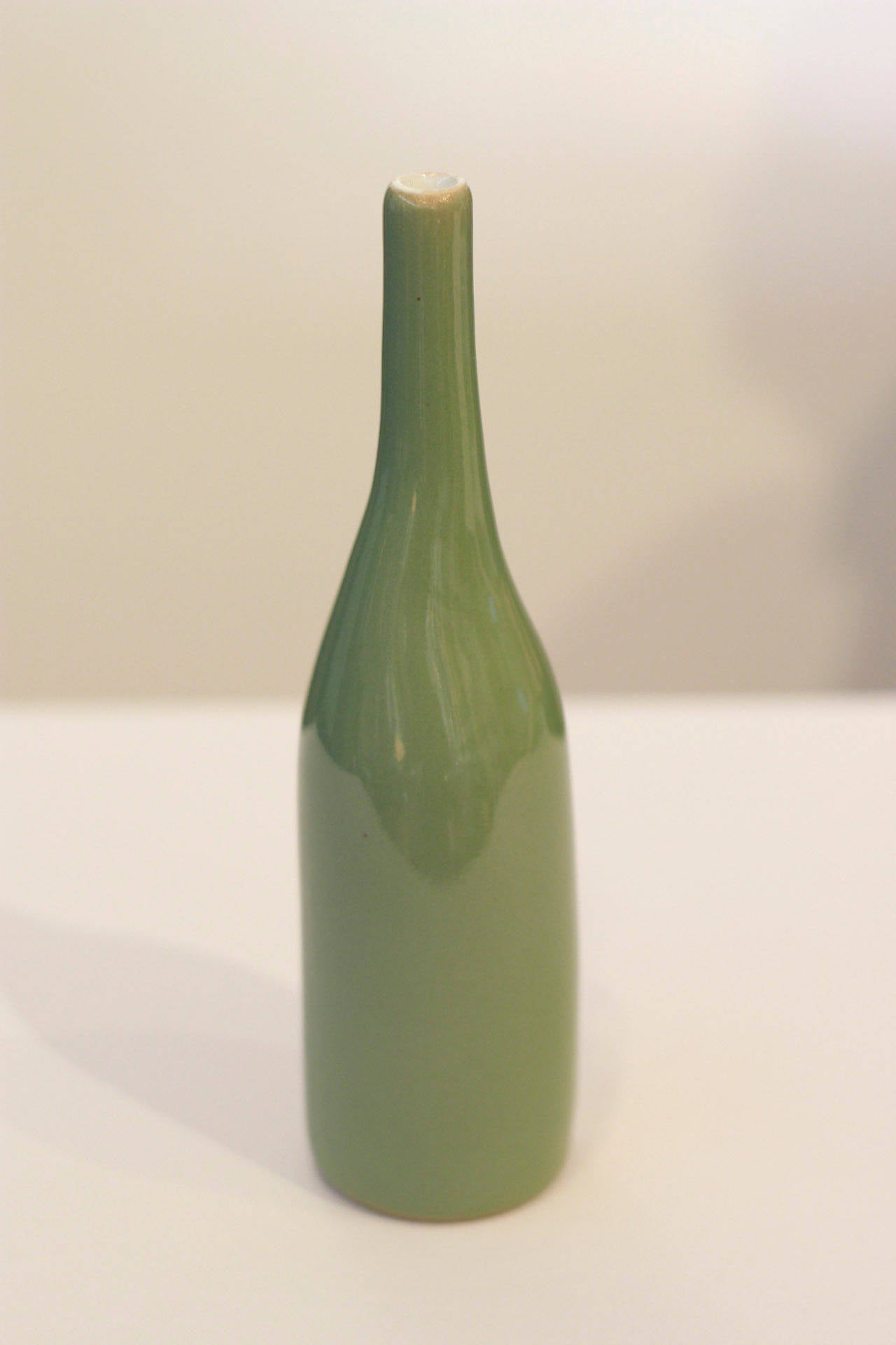Ceramist Jonn Coolidge's green bottle is glazed enamel stoneware. 
Each piece is signed by the artist. Additional pieces of Jonn Coolidge ceramics available through S16 Home, please contact the dealer for more information.

Artist Bio: 
American