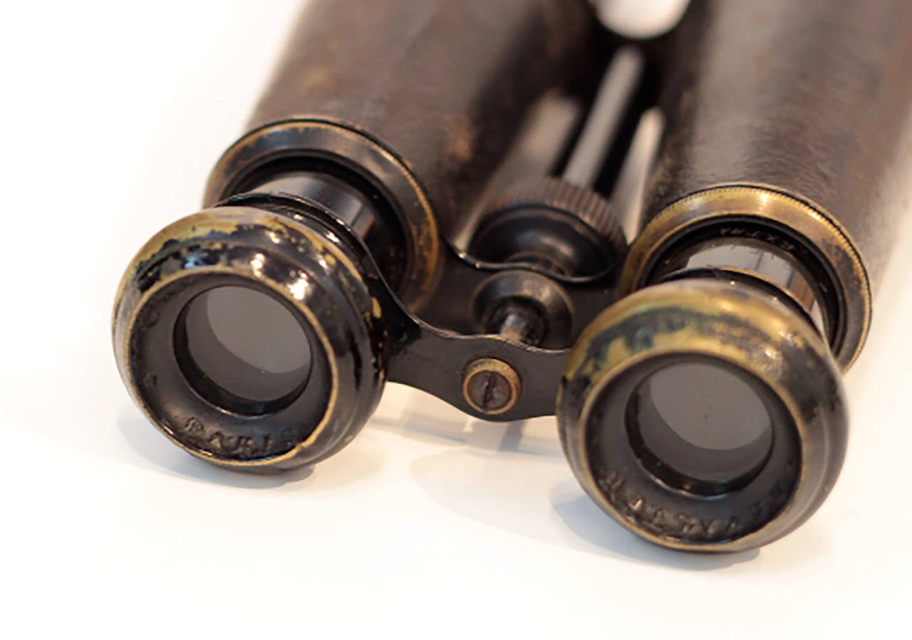 Large, expandable field binoculars by Chevalier Paris, Made in France. Binoculars are made of brass and metal wrapped in leather. Work great with very clear range for viewing.