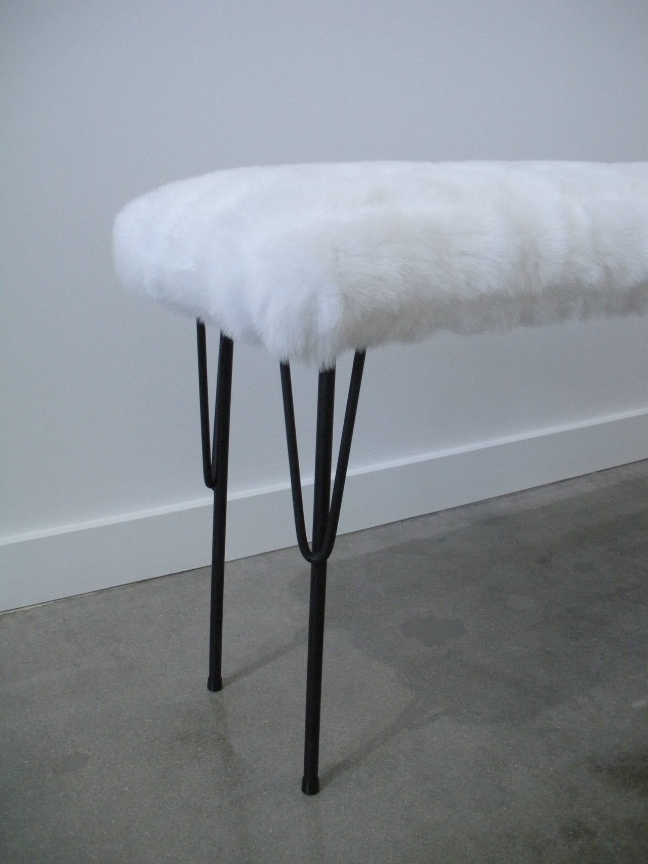 This slender rectangular bench was made in the 1950's is attributed to the iconic furniture designer Paul McCobb. The legs are iron which is painted black and the newly upholstered seat is in a white faux-fur fabric.

Paul McCobb, USA