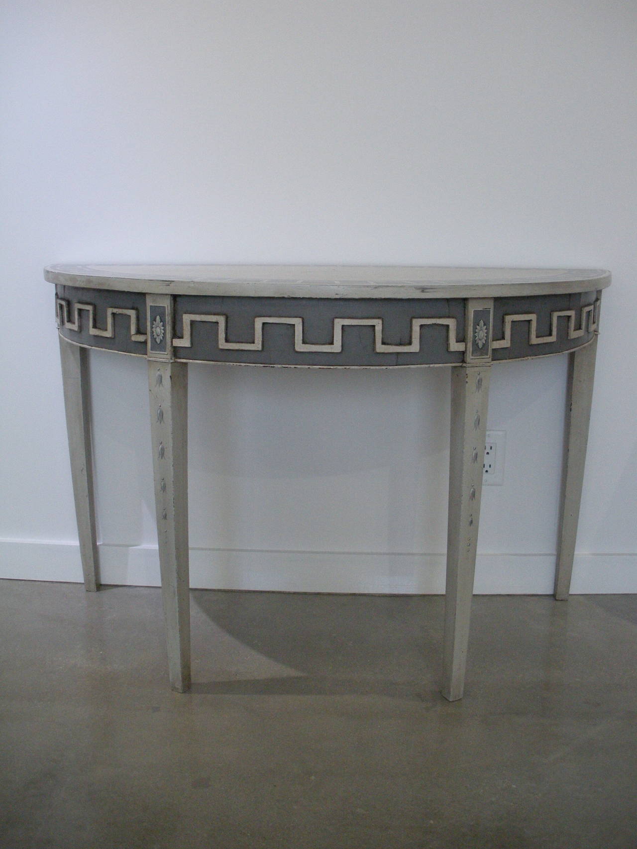 Pair of unusual classical French console hand-painted with a modified Greek key designs.

Please feel free to contact us directly for a shipping quote, or other questions and information including making an offer by clicking 