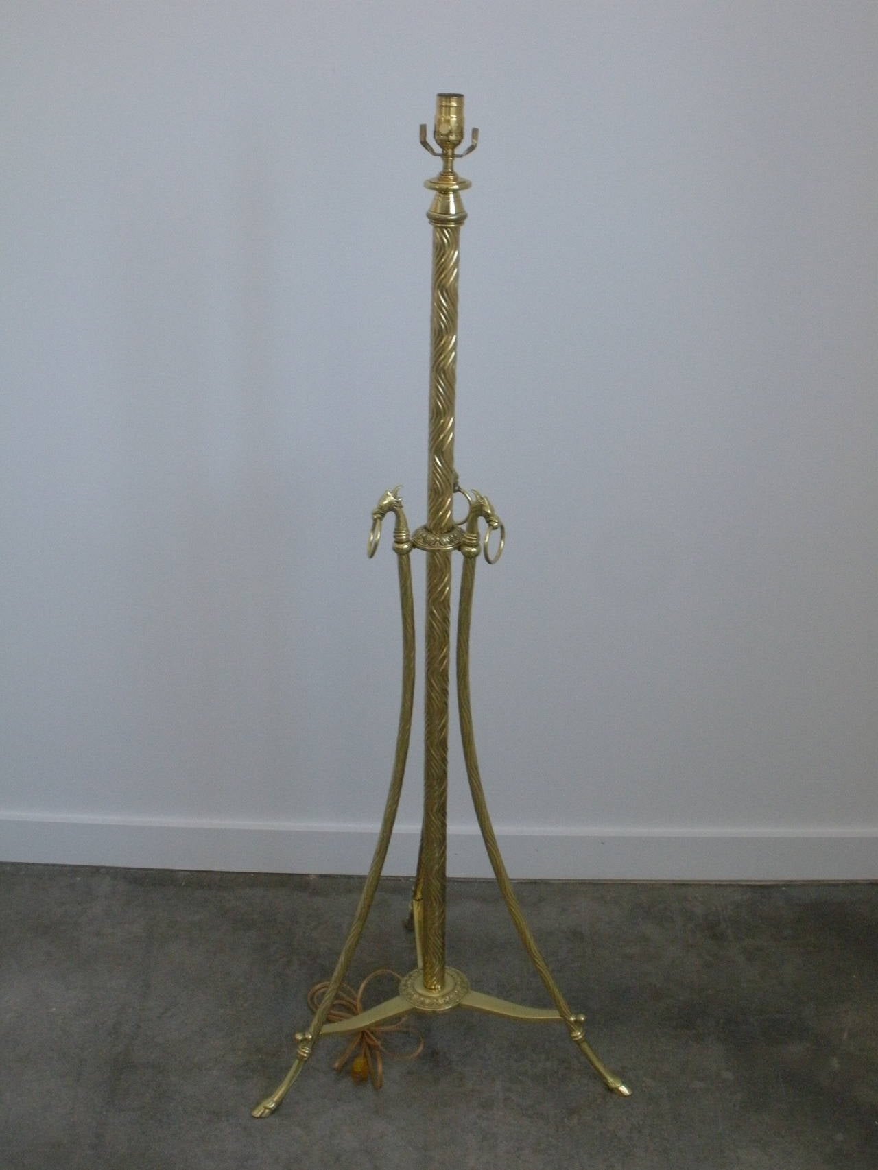 Spectacular detail and highly polished 1940s solid brass floor lamp with intricate wave and dragon motif.