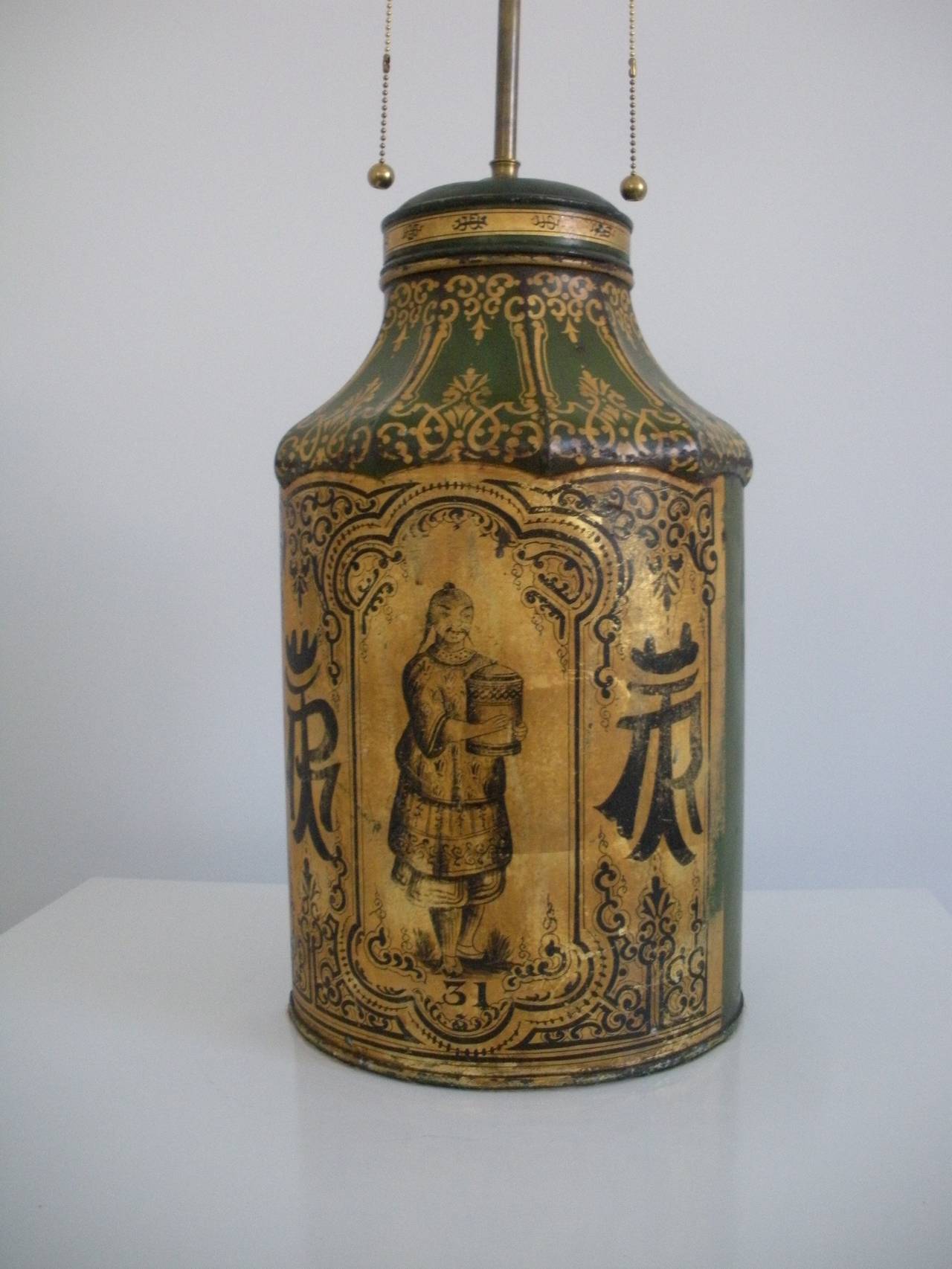 Antique Chinese tea jar converted to a lamp.
Semi circular with flat back and gold and black detailing with original patina and finish.