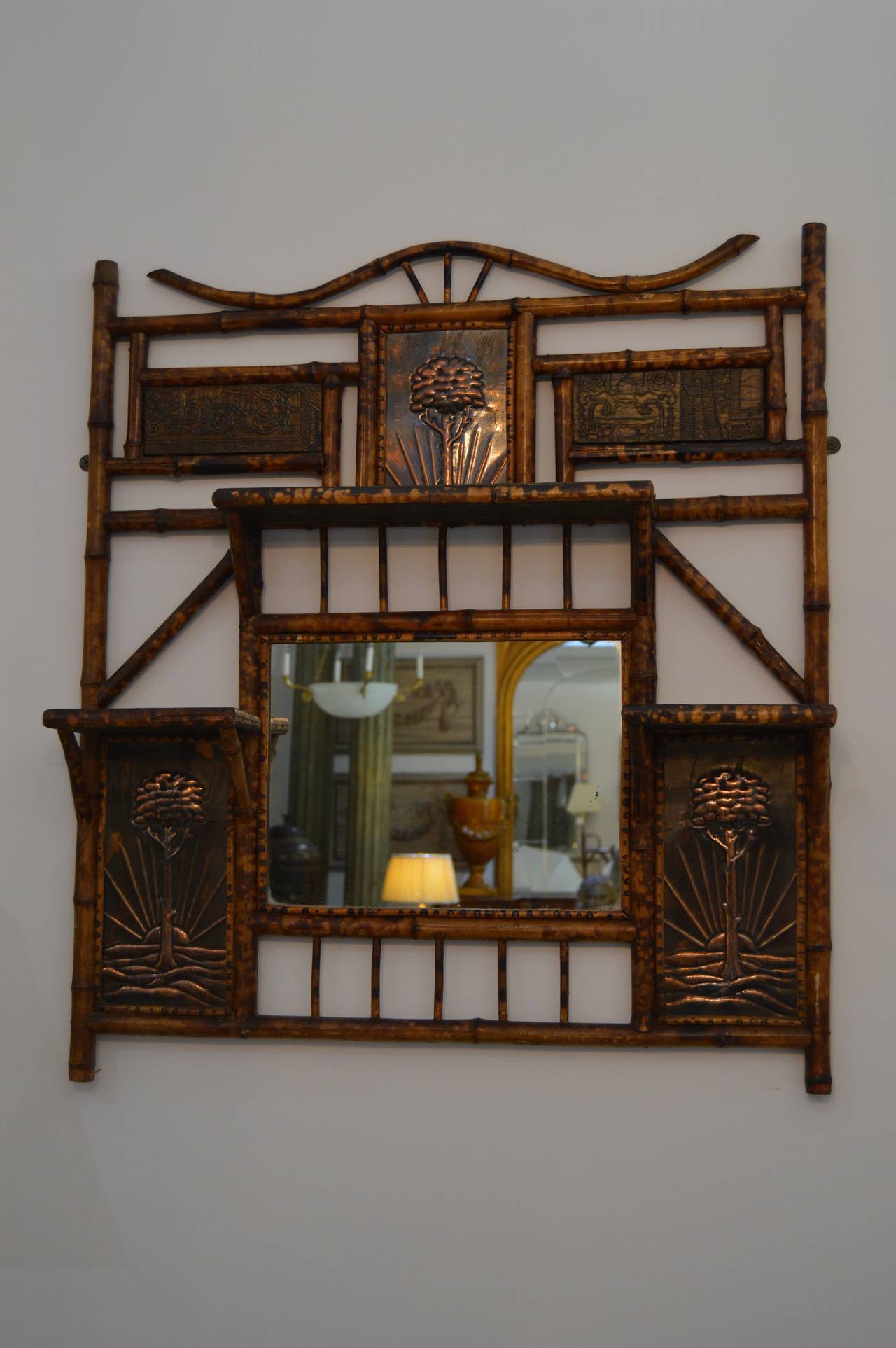 Exquisite early Victorian English bamboo mirror and shelf with beautiful copper decorative accents. This mirror measures 36.75 inches high by 32.75 inches wide. 

Please feel free to contact us directly for a shipping quote, or other questions and